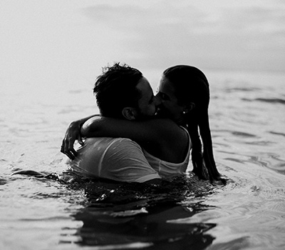 A couple kissing in the water demonstrating a healthy relationship after trauma and PTSD