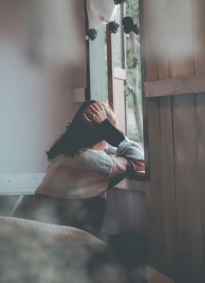 A woman stares out the window, clearly stressed, questioning if how she's being treated is abusive