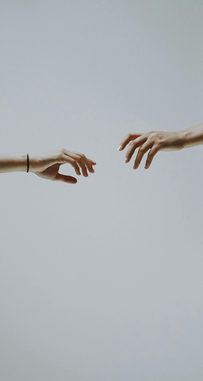 two hands reaching for eachother but unable to reach, implying how it can be difficult to trust relationships after trauma