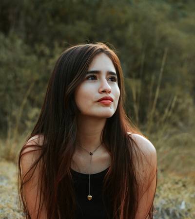 A woman sitting outside considering CPT or EMDR therapy for her PTSD symptoms A woman sitting outside considering CPT or EMDR therapy for her PTSD symptoms