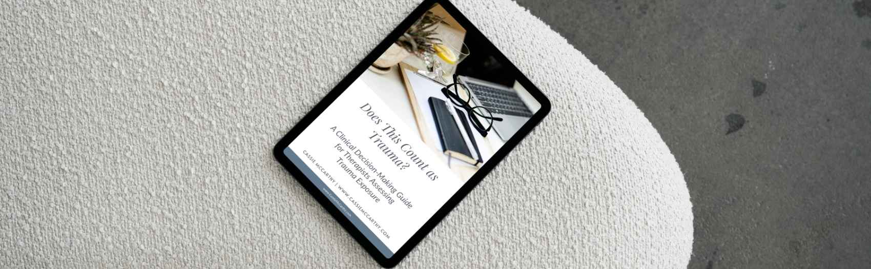 Does This Count As Trauma - A Clinical Decision-Making Guide for Therapists Assessing Trauma Exposure on a notebook