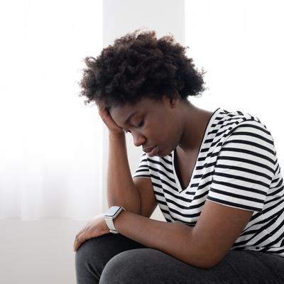 A Black woman struggling with anxiety and self-trust confidence problems after trauma