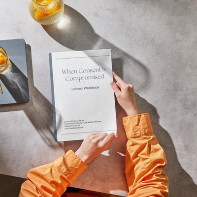 A printed copy of the learner workbook on a desk
