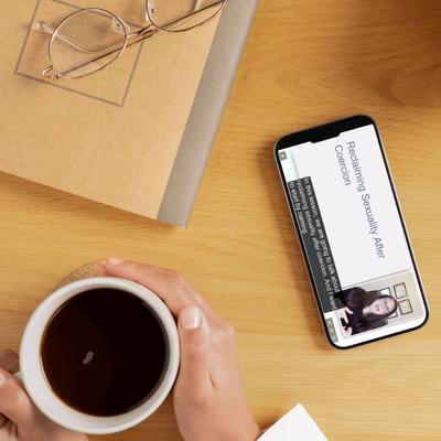 A woman watches her CEU course on her phone to fit in her busy schedule